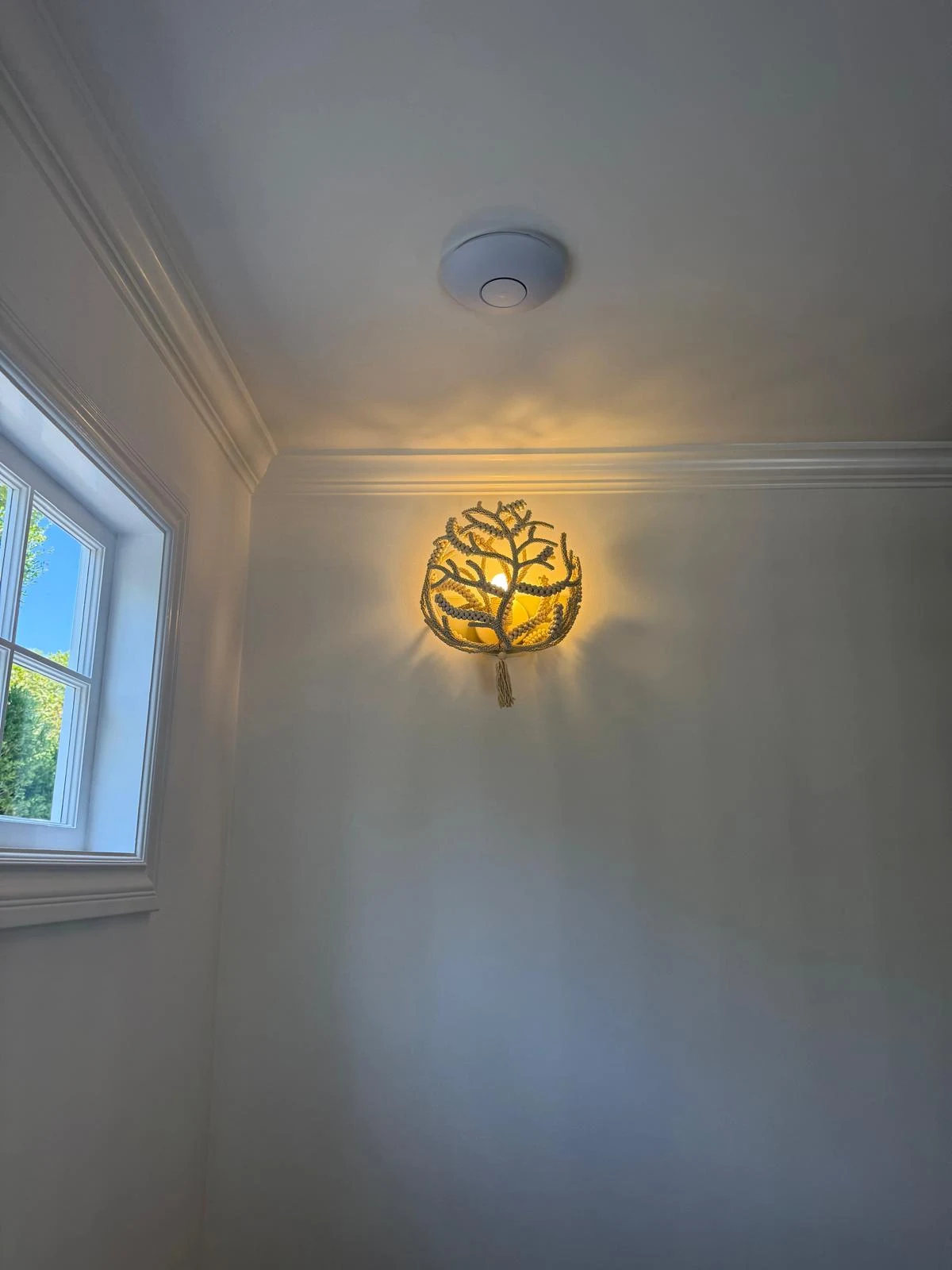 Decorative wall sconce light fixture, alternate angle